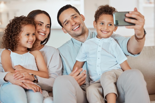 We have all these memories to look back on. Shot of a young family taking a selfie at home.