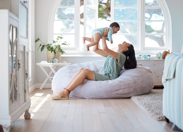 Photo we have a beautiful life. shot of a mother bonding with her baby at home.