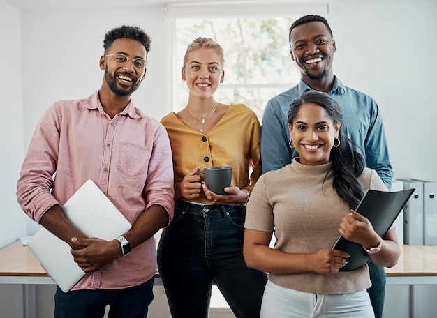 Photo we have some great plans for this business cropped portrait of a diverse group businesspeople standing together after a successful discussion in the office