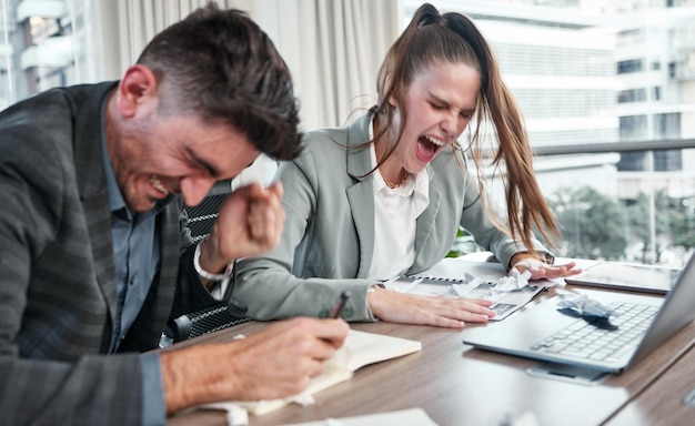 Photo we just have so much to do today shot of two businesspeople looking very upset in an office at work