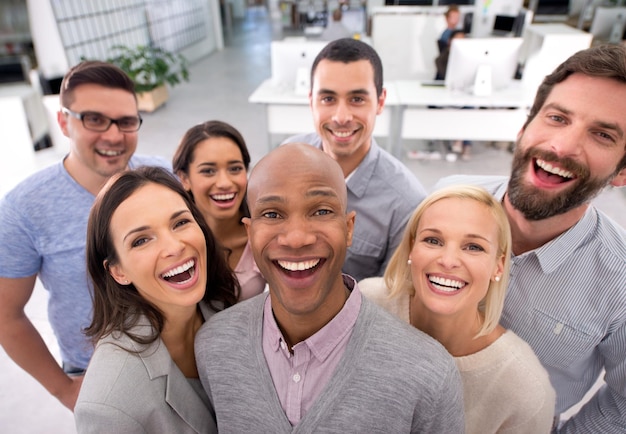 We love everything about out jobs High angle shot of a group of positive businesspeople