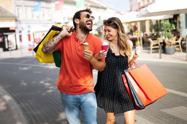 Photo we love shopping together. beautiful young loving couple walking by the street while shopping and traveling