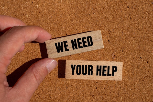 Photo we need your help words written on wooden blocks with brown background conceptual we need your help symbol copy space