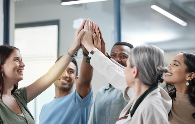 We promise to always support each other Shot of a group of businesspeople giving each other a high five in an office