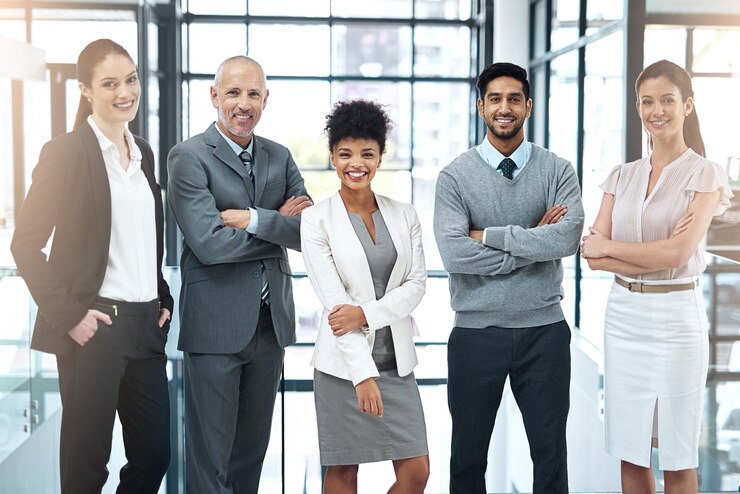 Photo we strive to be the best team in the business portrait of a happy group of colleagues standing together in a modern office