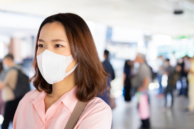 wear mask while waiting public transport in the station  for protect coronavirus