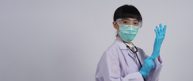 Wearing gloves Asian doctor wear blue rubber nitrile hands glove Doc with a mask putting on gloves