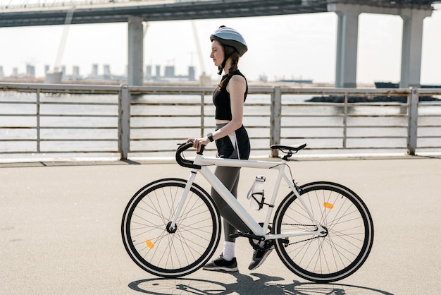 사진 낮에는 헬멧을 쓴 여성 자전거 타는 사람 행복한 사람의 건강한 생활 방식 자전거를 사용합니다