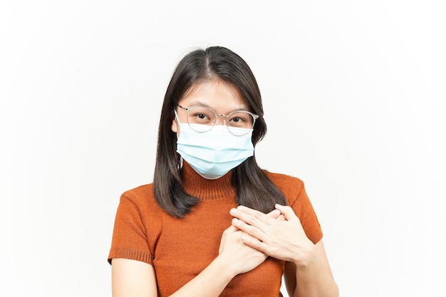 Wearing Medical Mask for Preventing Corona Virus and Self Love Gesture Of Beautiful Asian Woman Isolated On White Background