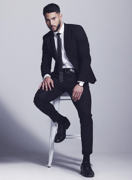 Wearing my best suit Studio shot of a young man posing against a grey background