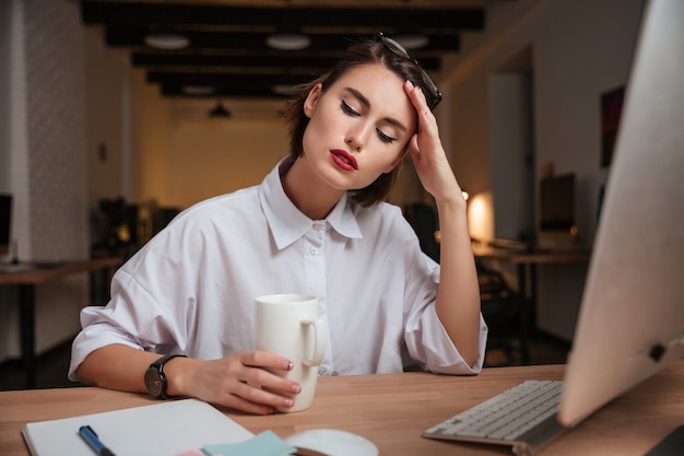 Weary office girl. hand near the face