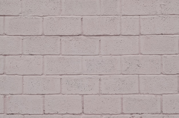 Weathered and stained colored pink block wall texture