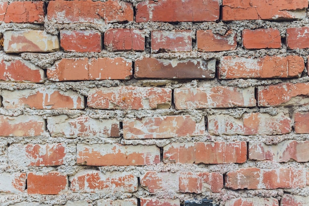 Weathered stained old brick wall background.