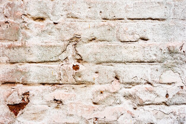 Weathered texture of stained old green and white brick wall background