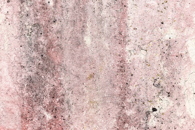 Weathered wall with humidity and pink and white paint residues