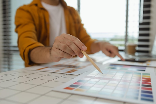 a web designer is using his idea to create a digital product design project that will meet the needs of users in terms of both appearance and feel when using it ux ui interface experience