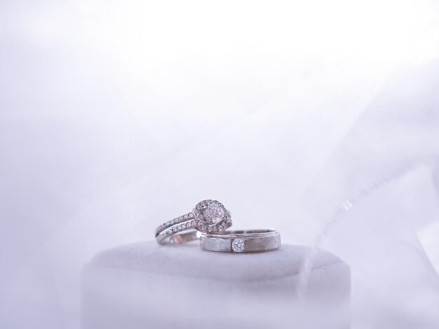 Wedding accessories Diamond engagement wedding rings on white box Valentine's day and Wedding day concept