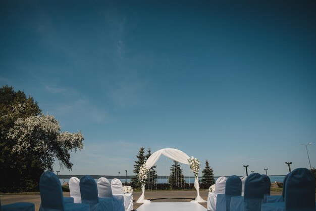 Wedding arch on the background of the lake and blue sky