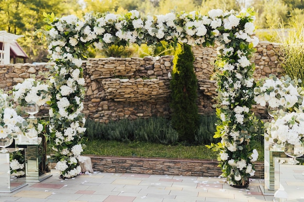 Wedding arch decorated with white flowers