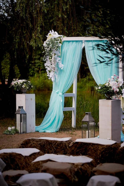 Wedding Arch of turquoise color on background lake