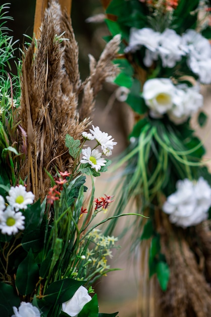 Wedding arch of white daisies and field ears