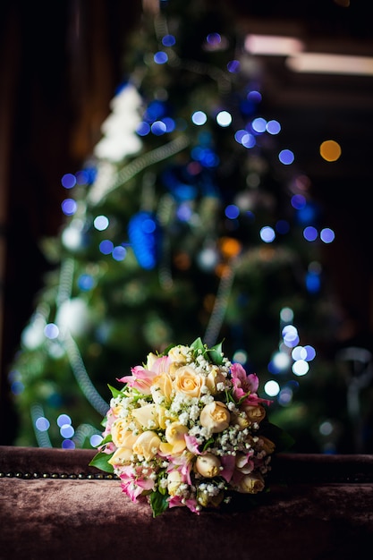 Wedding bouquet on a background of the christmas tree