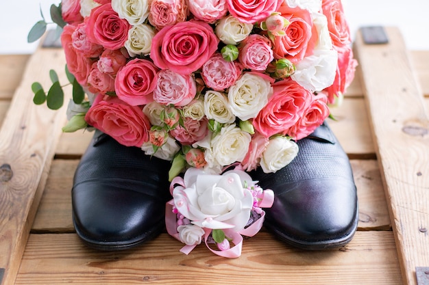 Wedding bouquet on black men's shoes