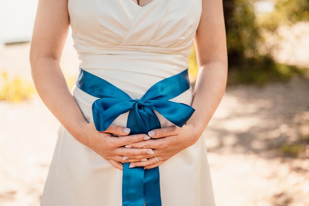 Wedding bouquet in bride's hands the bride in a beige dress holds the flowers wedding bouquet of flowers and greenery