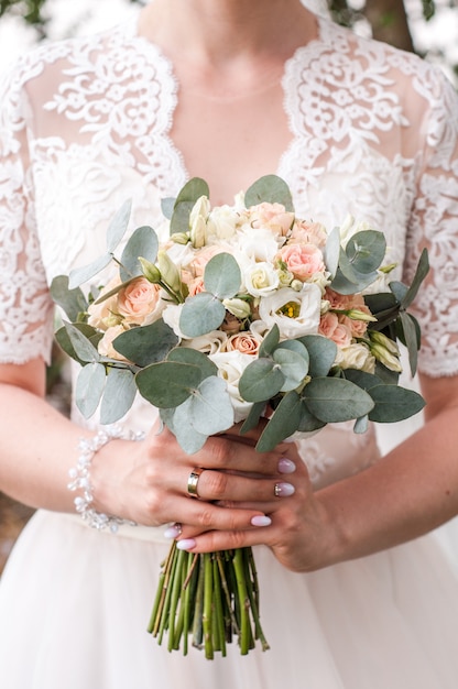 Wedding bouquet in bride's hands, david austin