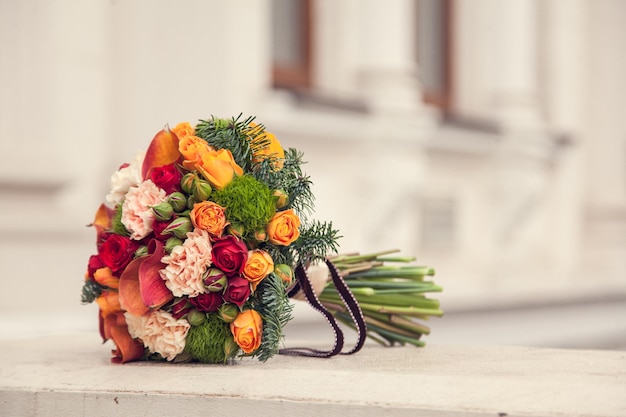 Wedding bouquet of the bride in winter or autumn style against a blurry background