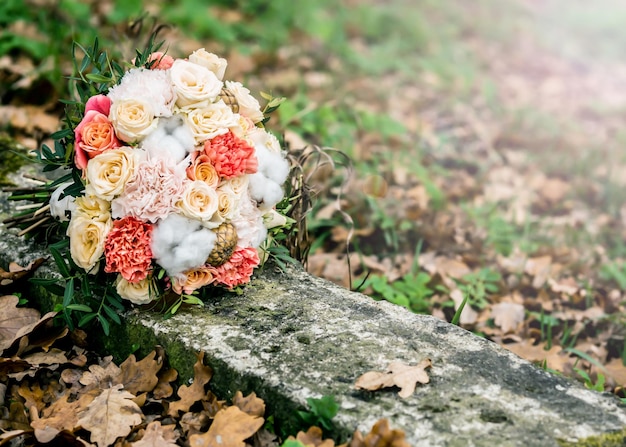 Wedding bouquet of different flowers lying on the ground