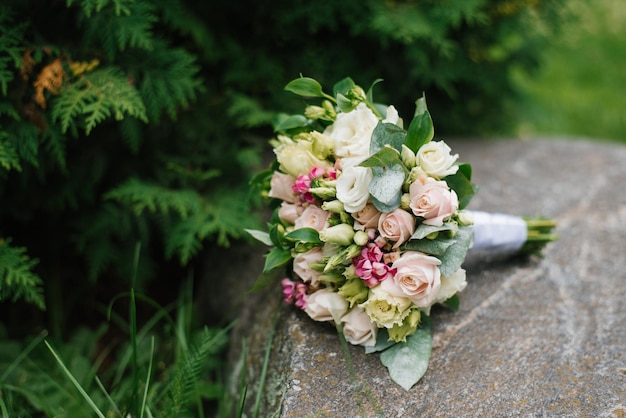 Wedding bouquet of flowers on the old stone