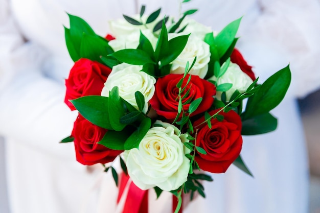 Wedding bouquet in the hands of the bride closeup