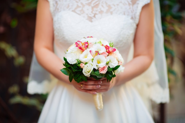 Wedding bouquet in the hands of a bride