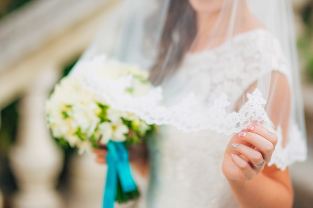 Wedding bouquet in hands of the bride