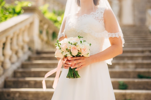 Wedding bouquet in hands of the bride