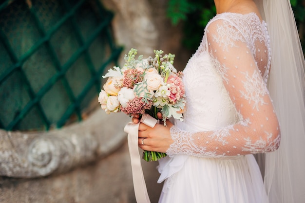 Wedding bouquet in hands of the bride