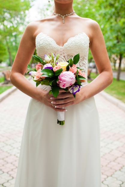 Wedding bouquet in hands of the bride