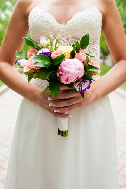 Wedding bouquet in hands of the bride