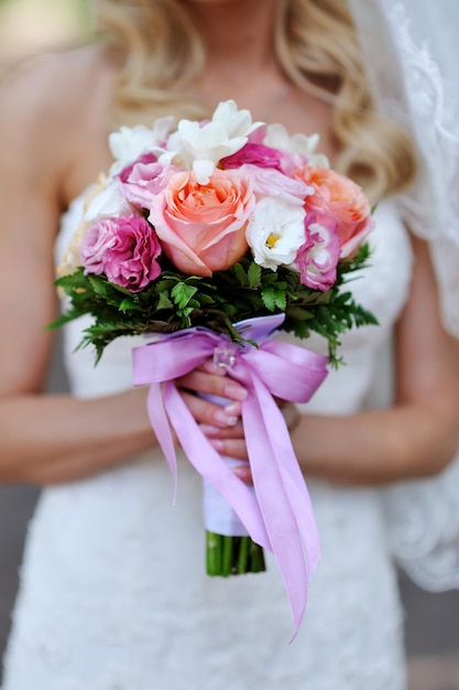 Wedding bouquet in hands of the bride