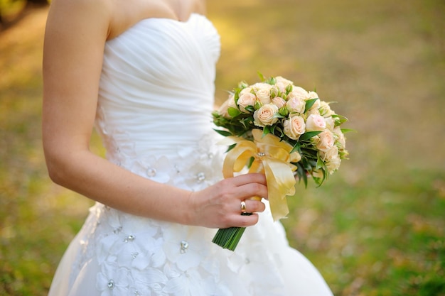 Wedding bouquet in the hands of the bride