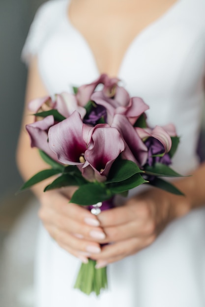 Wedding bouquet in the hands of the bride