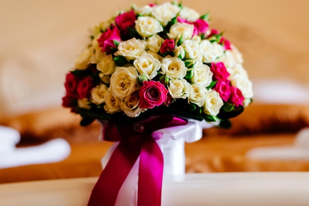 Wedding bouquet in a hotel room on a bed