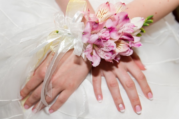 Wedding bouquet of orchids and roses in hand the bride