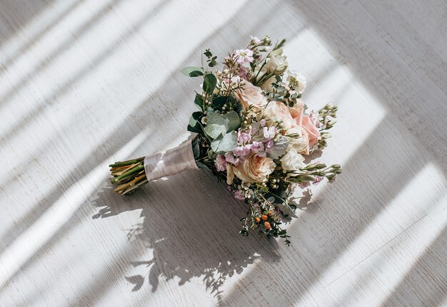 Wedding bouquet of peonies flowers on the floor of the newlyweds