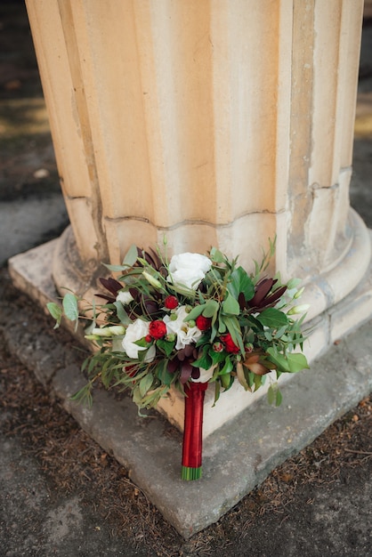 Wedding bouquet of red flowers and greenery