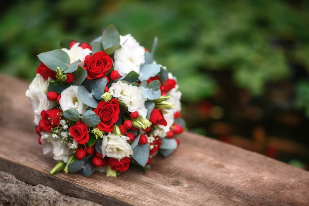 Wedding bouquet of roses on wooden surface