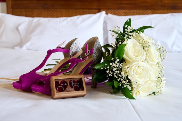 Wedding bouquet and shoes on the bed in the bedroom