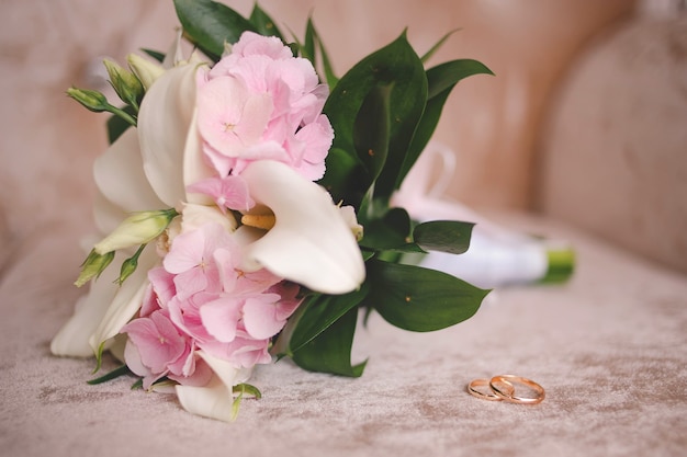 Wedding bouquet and wedding rings for bride and groom