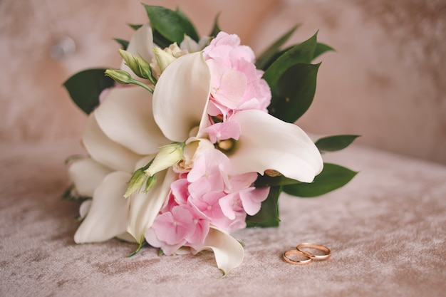 Wedding bouquet and wedding rings for bride and groom